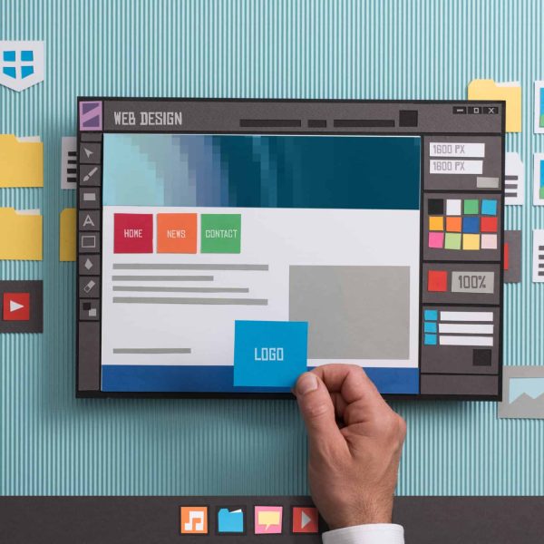 Web designer drafting web templates and web page layouts using a professional software, collage and paper cut composition